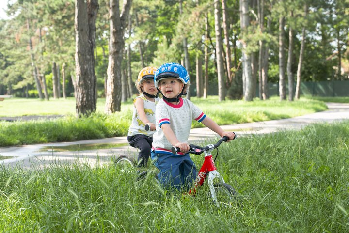 Two kids with their balance bikes
